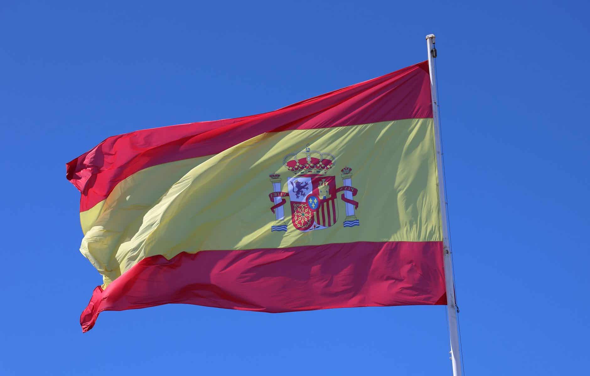 spanish national flag waving against clear blue sky